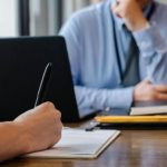 Resume Pen - Crop anonymous female filling questionnaire when applying for job sitting in employer office