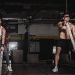 CrossFit Training - Man And Woman Holding Battle Ropes