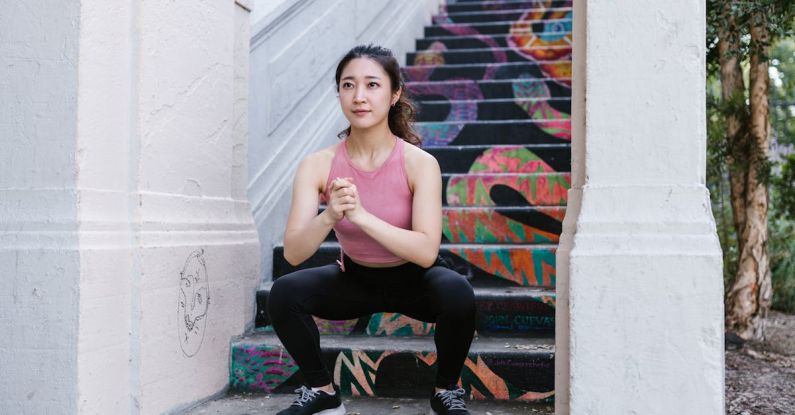 Calisthenics Training - Woman Squatting Beside the Stairs