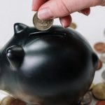 Money Piggy Bank - Person Putting Coin in a Piggy Bank