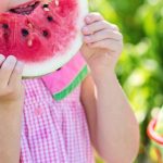 Child Eating - Girl Eating Sliced Watermelon Fruit Beside Table