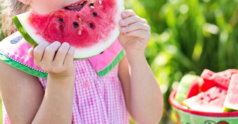 Child Eating - Girl Eating Sliced Watermelon Fruit Beside Table