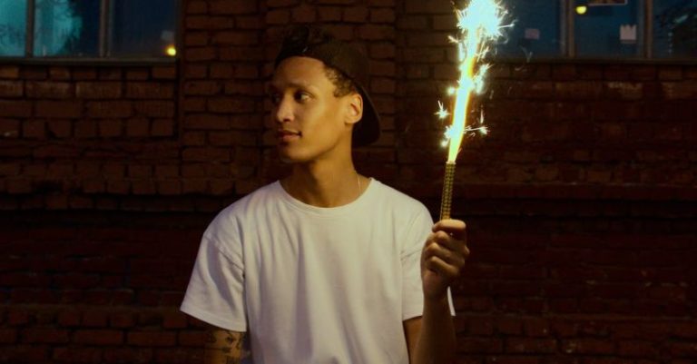 Teen Rebellion - Man in White Crew Neck T-shirt Holding Fire