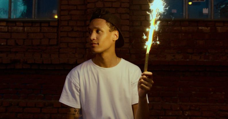 Teen Rebellion - Man in White Crew Neck T-shirt Holding Fire