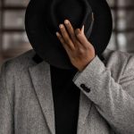 Good Posture - Person in Gray Coat Holding Black Hat