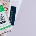 Immune Boost - Smart Phone with a Health Passport App and Travel Documents Lying on a Table