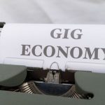 Side Hustles - A typewriter with the word gig economy on it