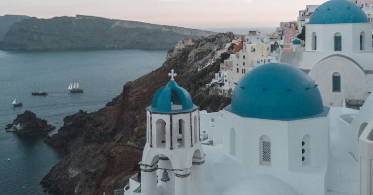 Santorini Sunset - White and Blue Concrete Building Near Body of Water