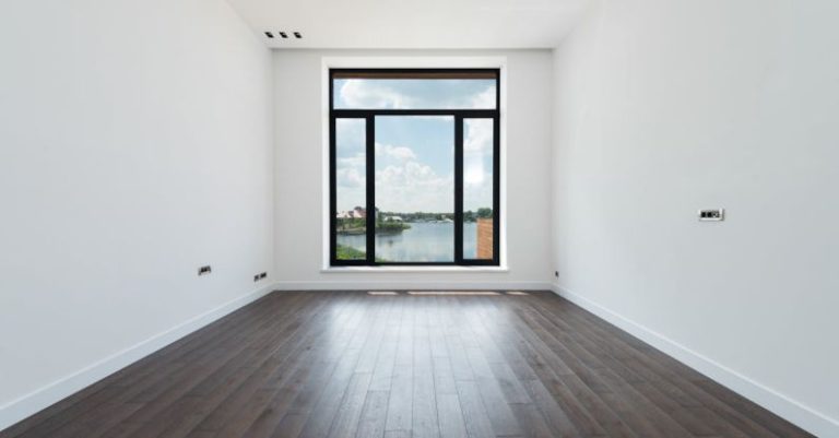 Apartment Space Saving - Interior of modern spacious light room with wooden laminate floor white walls and panoramic windows