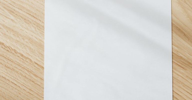 Rustic Home Decor - Blank white paper sheet on wooden table