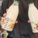 Almond Milk - Person Holding Bottles with Milk