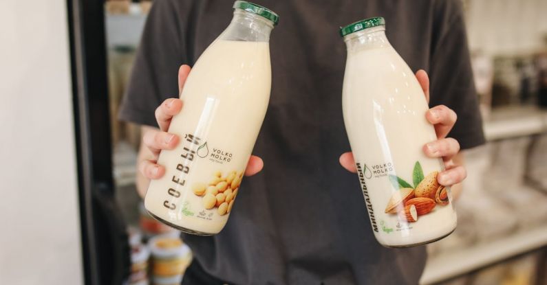 Almond Milk - Person Holding Bottles with Milk