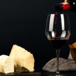 Wine Pairing - Photo of Person Pouring Wine into Glass besides Some Cheese Pairings