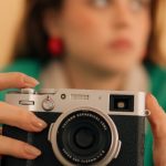 Photography Camera - A woman holding a camera in her hand