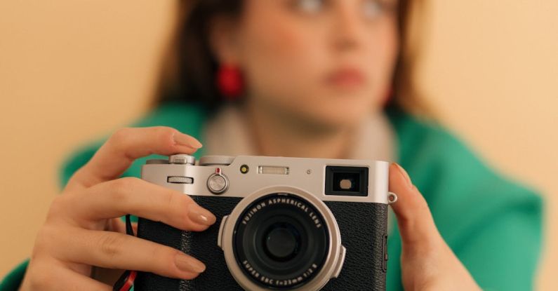 Photography Camera - A woman holding a camera in her hand